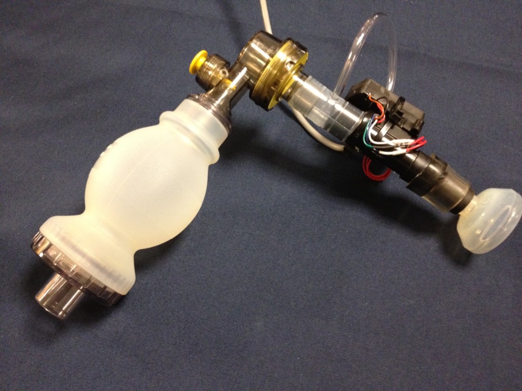 The original proof of concept prototype installed in the air path of a Laerdal bag valve mask.